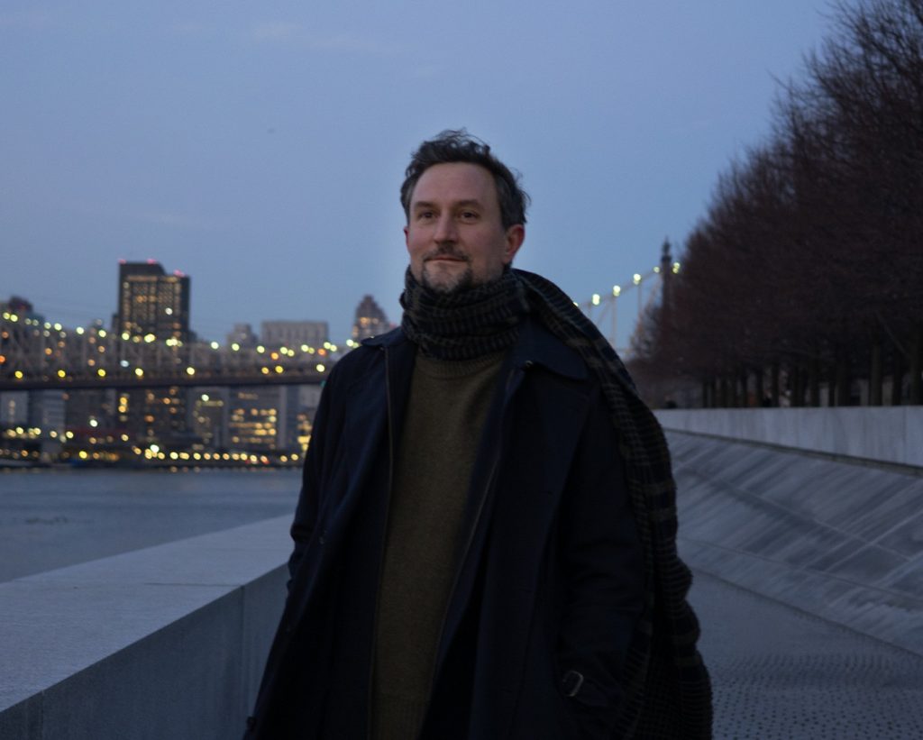 Photograph of Hans Rosenstrom at FDR Four Freedoms Park with the NYC skyline and Queensboro Bridge in the background